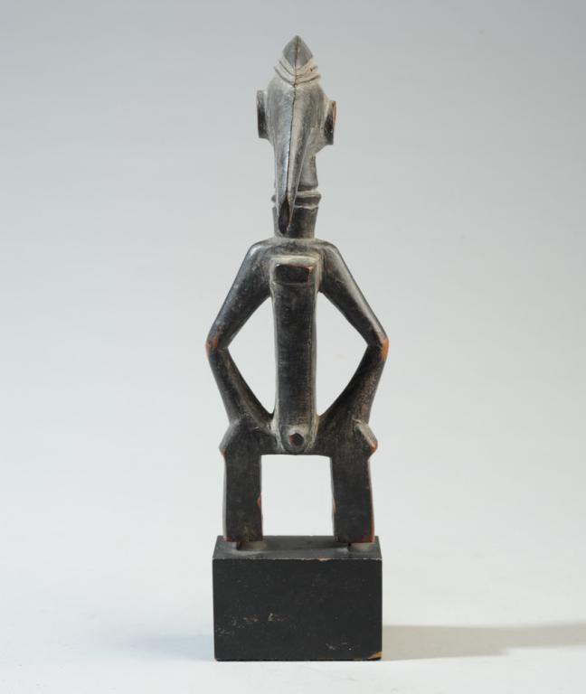 Senufo Hornbill Heddle Pulley: Carved wood pulley in the form of a standing figure with Hornbill bird head. Mounted to custom gallery base. Probably Senufo people, Ivory Coast. Provenance: Estate of Thomas McNemar, (1931-2019.) McN
