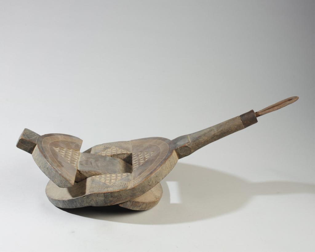 Zamaro Seat Coconut Grater, Tanzania: Folding low seat with saw tooth tool projecting from one end allowing the user to sit and grate coconut meat from the shell, to be pressed into coconut milk. Carved and incised designs, unusual round