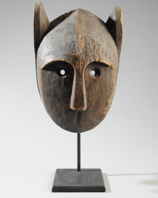 Dogon Animal Mask: Carved wood mask, probably representing a lion, with small round eye holes, upright ears and pointed teeth. Dogon people, Mali. Approx. 13" x 9". Provenance: Estate of Thomas McNemar, (1931-2019.) McN