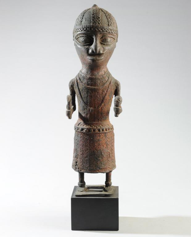 Benin Bronze Oba Warrior Figure: On gallery stand. Collected Awka, Nigeria, prior to 1966. Figure, approx. 15 3/4" in height. With stand, approx. 18 1/2". Provenance: Estate of Thomas McNemar, (1931-2019.) McNemar lived and collected