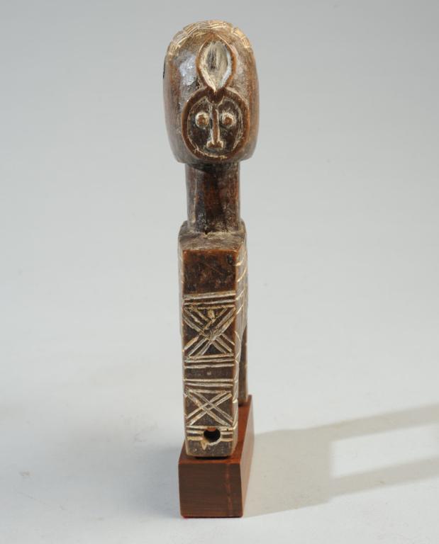 Baule Goli African Heddle Pulley: Janiform heddle pulley, one side with a human face with coffee bean eyes, careful coiffure, refined features, the other face a Goli mask. Long slender neck, the body of the pulley embellished with inc