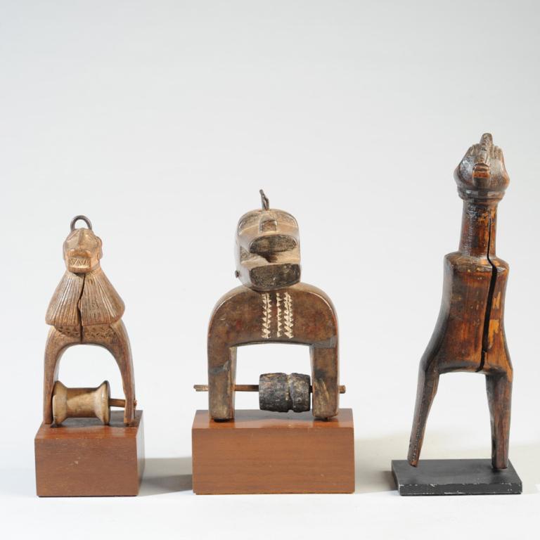 Three Zoomorphic African Heddle Pulleys: West African heddle pulleys, the finials in the form of a bush cow, a monkey, and a bird. Baule? All on gallery bases. Stable splits. The tallest, (bird figure,) approx. 8 1/4" H., with base approx. 8