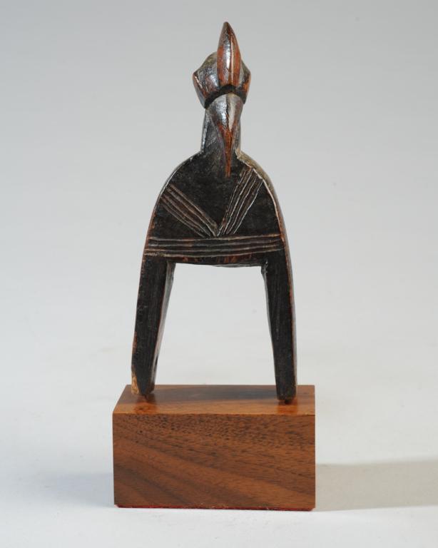 Senufo African Heddle Pulley: Bird head form with curved beak, crested head, incised decoration. Senufo people, Ivory Coast. On gallery base. Pulley, approx. 6 1/4" H. Provenance: Estate of Thomas McNemar, (1931-2019.) McNemar liv