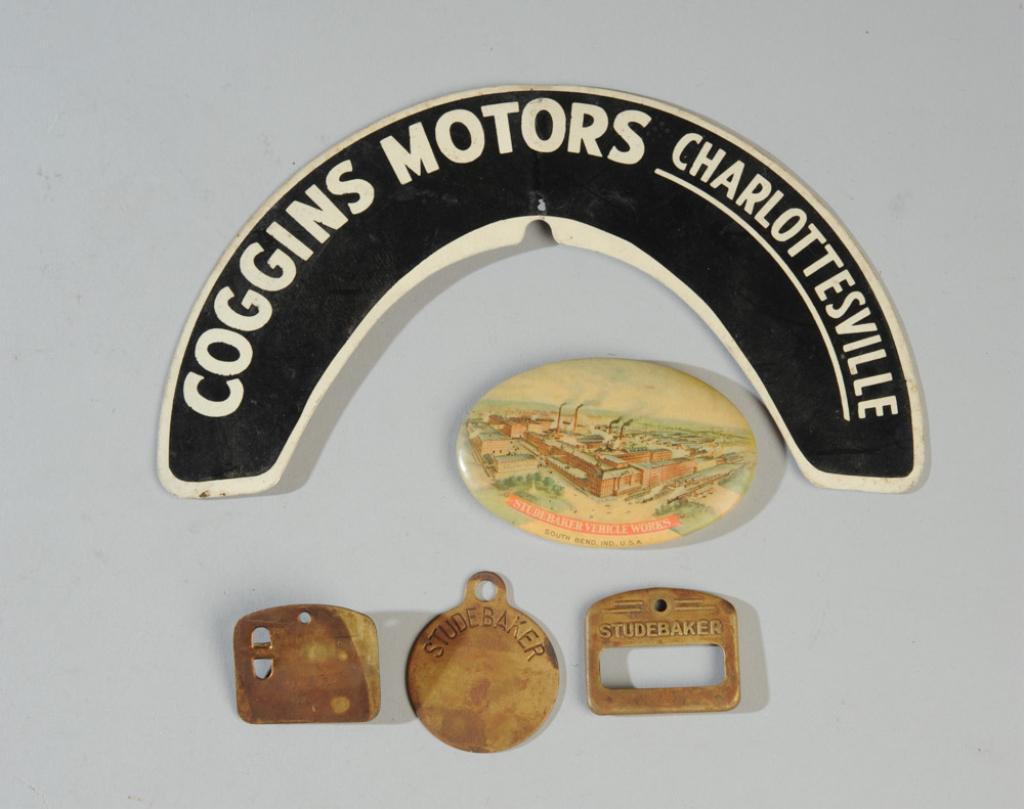 Studebaker & Charlottesville Lot: Celluloid pocket mirror "Studebaker Vehicle Works South Bend, Ind. USA", Studebaker employee badge & keychain, together with Coggins Motors Charlottesivlle tin plate. Coggins Motors was the Studebaker