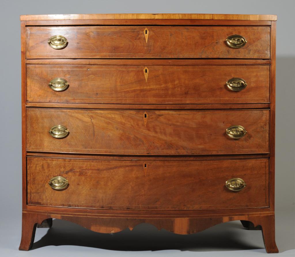 19th C. Federal Bowfront Inlaid Chest of Drawers: With four graduated dovetailed drawers with brass hardware (replaced, no key,) string inlay and kite escutcheons, flared feet, in as-found condition.H: approx. 39 1/2".W: approx. 42".D: approx. 20 1/2