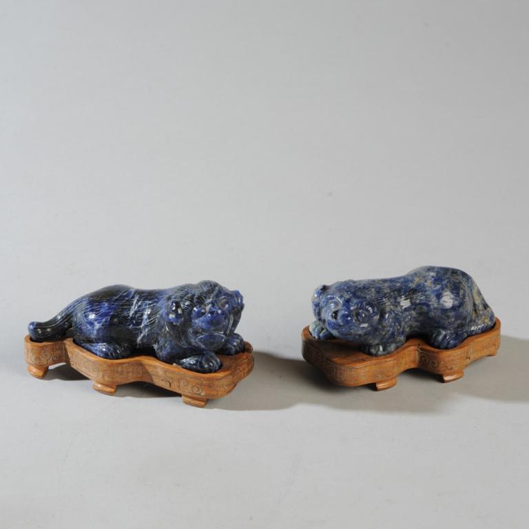 Pair Chinese Carved Lapis Foo Dogs: Carved lapis lazuli foo dogs, each on a carved wood and gold wire inlay stand. Each approx.2" x 4" x 2".