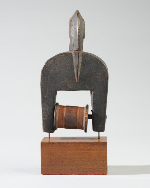 A West African Heddle Pulley: Of abstract avian form, with crested head and long beak. Probably Senufo, although a sticker on the bottom has "bobo" written in ink. Approx. 6 1/2" H. Provenance: Estate of Thomas McNemar, (1931-2020