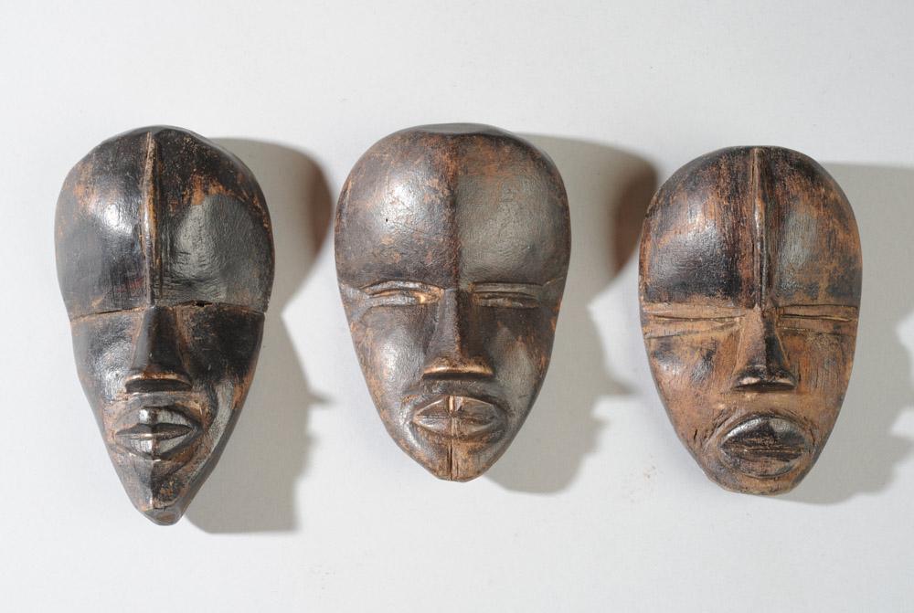 Three Dan Passport Masks: Three miniature masks of the 'deangle' type, having idealized features, calm expressions, narrow slit eyes. Largest approx. 5 3/4" x 2 1/2". Provenance: Estate of Thomas McNemar, (1931-2020.) McNemar 