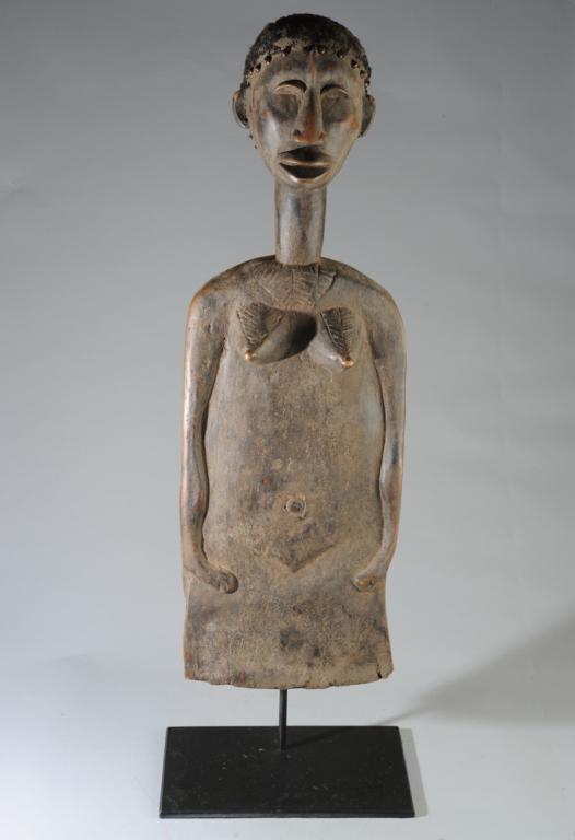 Dan Figural Shield: In the form of a female figure. Carved wood, human hair. Dan people, Ivory Coast. H: approx. 37 1/2".Provenance: Estate of Thomas McNemar, (1931-2020.) McNemar lived and collected throughout Central a