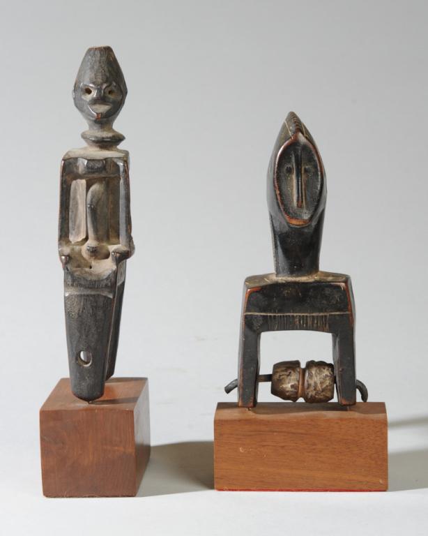 Two African Heddle Pulleys: Carved wood figural pulleys mounted to gallery stands. Tallest, approx. 8 1/2" Provenance: Estate of Thomas McNemar, (1931-2020.) McNemar lived and collected throughout Central and West Africa in the
