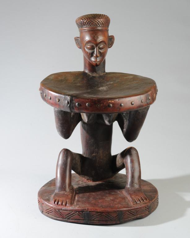 Lwena or Chokwe Prestige Stool: Carved wood stool with seated female figure supporting the round seat. Cracks to seat, one leg, base. Approx. 23" total height, seat height approx. 15".Provenance: Estate of Thomas McNemar, (1931-2020