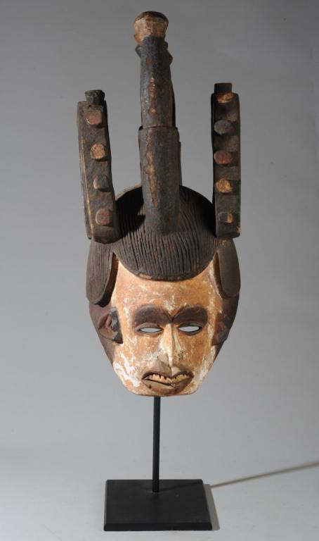 Igbo "Agbogho Mmwo" Maiden Spirit Mask: Large helmet mask representing female beauty, as used by male dancers. Carved wood and pigments. Igbo people, Nigeria. Approx. 26" H x 14" L x 11" W. Provenance: Estate of Thomas McNemar, (1931-2020.)