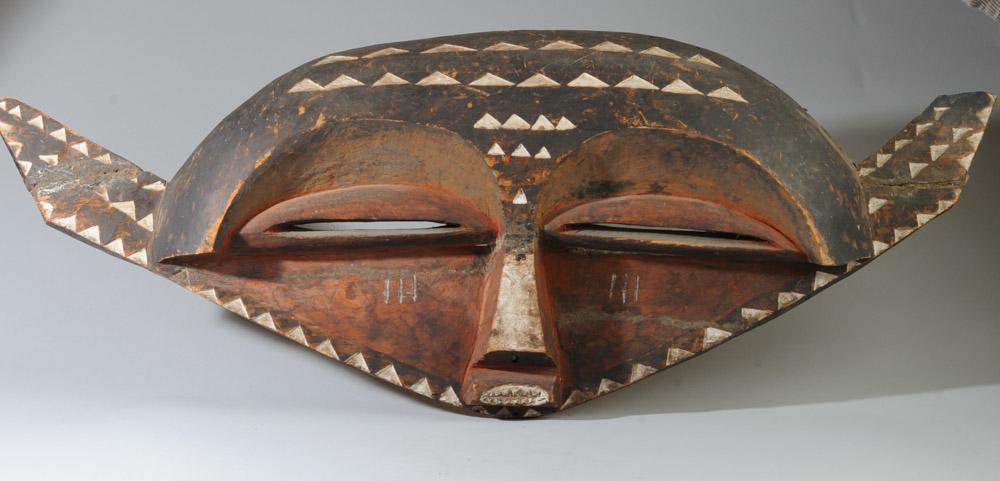 African Monumental Eastern Pende Mask: Eastern Pende "panya ngombe" buffalo mask. Carved wood and pigments. Approx. 43" x 17".Provenance: Estate of Thomas McNemar, (1931-2020.) McNemar lived and collected throughout Central and West Africa