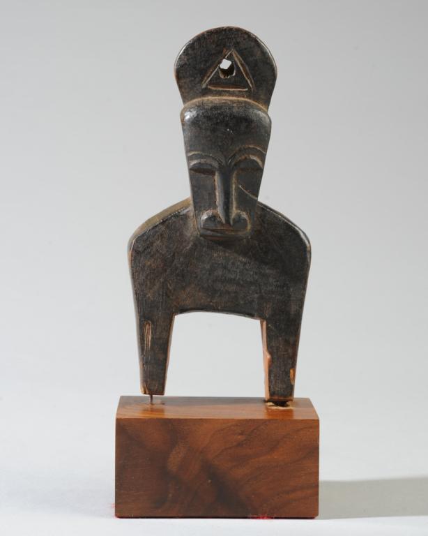 Baule Zoomorphic Heddle Pulley: Resembling a bush cow, the arched eyebrows, half moon eyes and long nose presenting horned but almost human face from the front, the arched neck and big toothy mouth visible from the side, with beauti