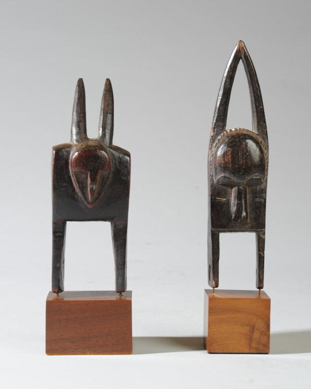 Two African Heddle Pulleys: Horned or long-eared zoomorphic pulleys on custom gallery stands. Pulleys approx. 6 1/4" and 7 1/4" H. Provenance: Estate of Thomas McNemar, (1931-2020.) McNemar lived and collected throughout Central