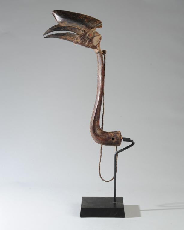Hausa Hornbill Decoy Headcrest, Nigeria: Headdress made of a hornbill skull, wrapped with antelope or goat hide and worn by Hausa hunters who would mimic the bird's movements, luring them close. Nigeria. On custom gallery stand. Headdress, a