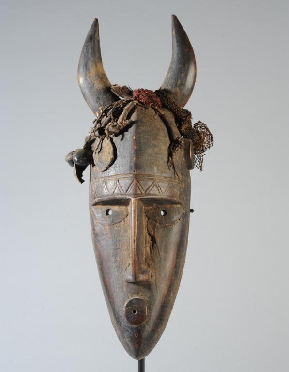 Marka Mask, Mali: Long, narrow head topped by curving horns, with incised zig-zag across brow, highly placed disc shaped ears, the narrow nose extending the subtle cranial ridge, the raised disc mouth echoing the form