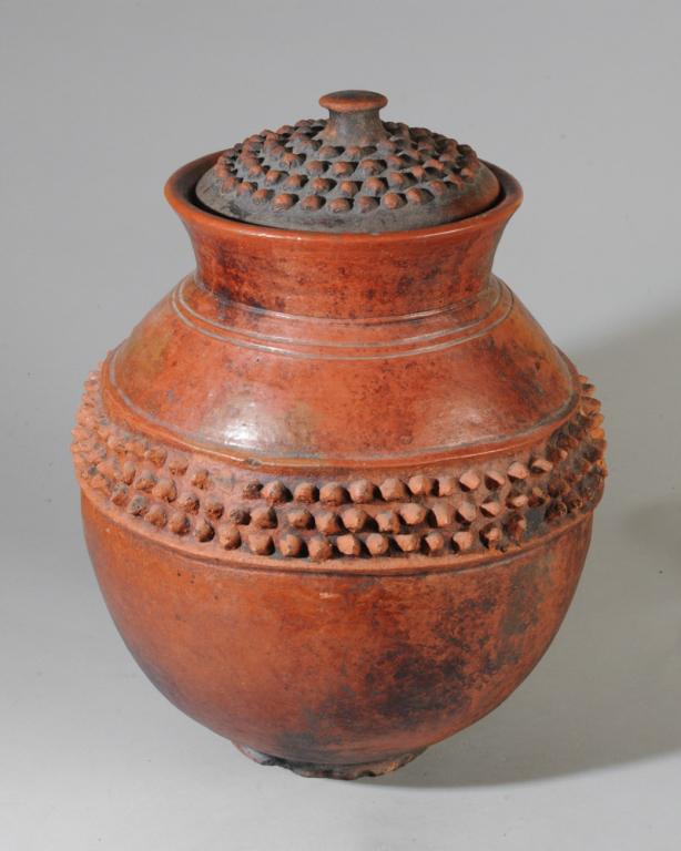 Lobi Lidded Pot: Round terracotta pot with rich red orange color, applied studs to central band and lid. Burnished surface. Lobi people, Burkina Faso /Ivory Coast. Sits flat. A few broken studs, overall good condition