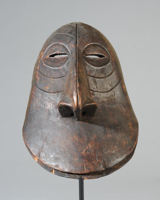 Hemba Soko Mutu Mask: Face mask representing the ape, in this case with an oversized and very human nose, and with the low forehead, arched brows, and wide flat upward curving upper lip typical of Soko Mutu masks. Hemba pe