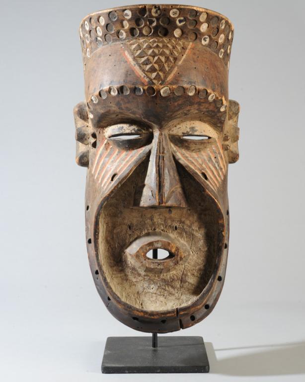 Kuba Helmet Mask: Likely a Bwoom mask, large size with heavy overhanging brow above half closed eyes and prominent nose, the protruding lips set within a flat plane defined by a ridge swooping along the cheekbones and