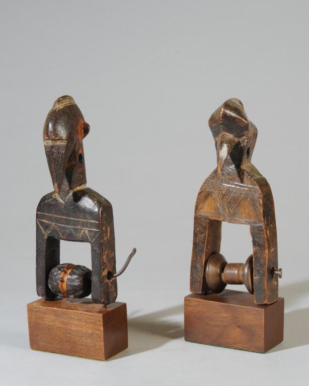 Two Senufo Heddle Pulleys: Both of abstract avian form, incised details. Both on custom gallery stands. Senufo people, Ivory Coast. Height of pulleys, approx. 7". Provenance: Estate of Thomas McNemar, (1931-2020.) McNemar lived