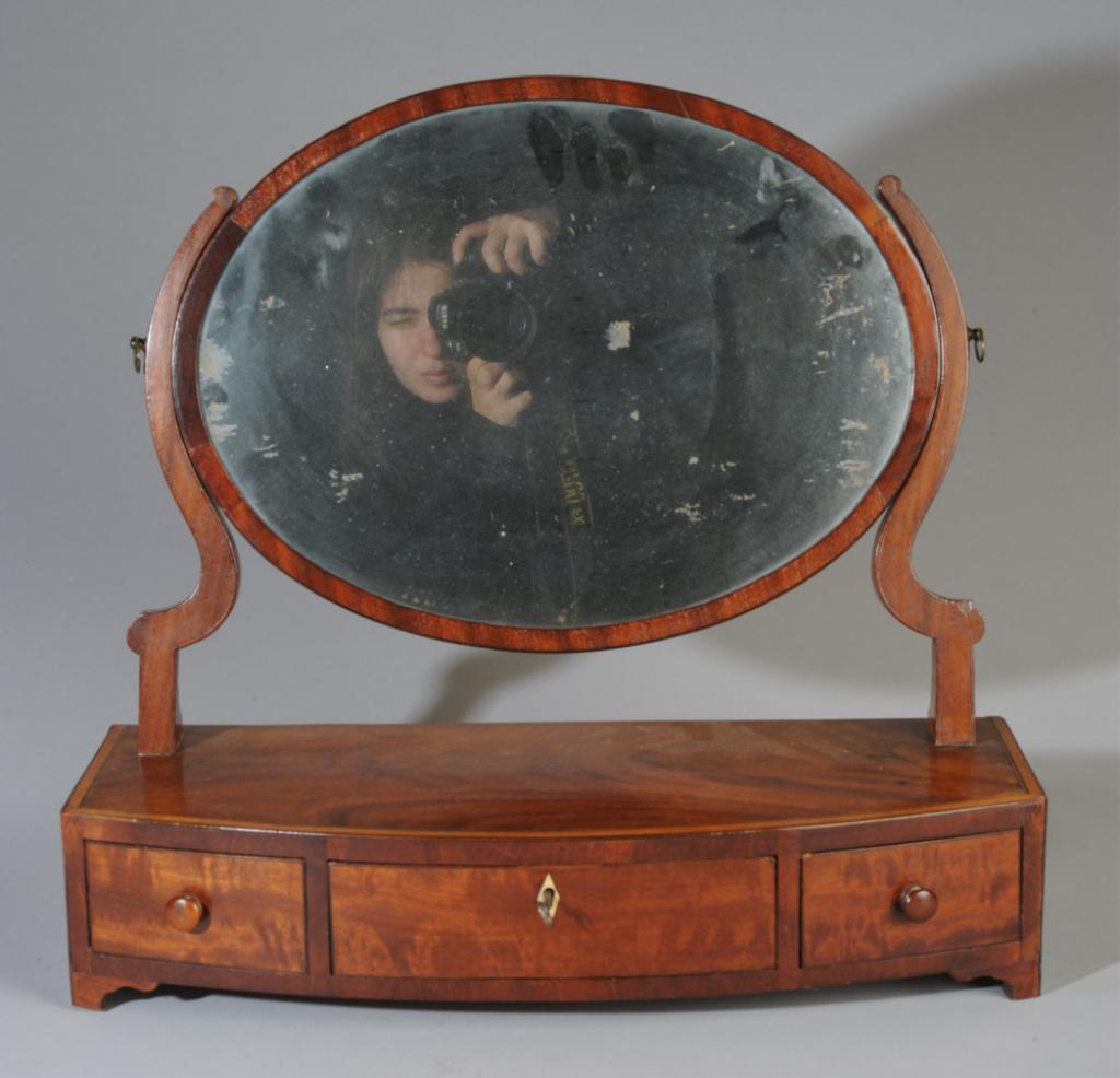 Antique Inlaid Shaving Stand: Looking glass over inlaid top over long dovetailed drawer with bone escutcheon flanked by two drawers with wooden pulls. In as-found condition.H: approx. 19"W: approx. 20 1/2"D: approx. 8 1/2"