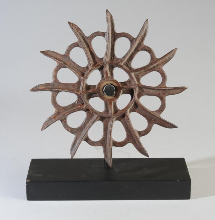 Antique Iron Rotary Hoe Blade: Cast iron cultivator wheel, mounted to gallery stand as the piece of art that it is. Approx. diameter: 12 1/2" Height with mount: 15 1/2"