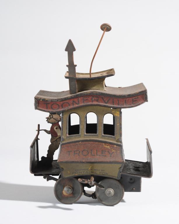 Fontaine Fox's Toonerville Trolley Wind-Up Toy: Tin litho trolley toy based on the comic strip by Fontaine Fox. Figure of 'Dan the Skipper' drives the trolley, which is meant to move in a jerky, side to side motion when wound up, as the troublesome