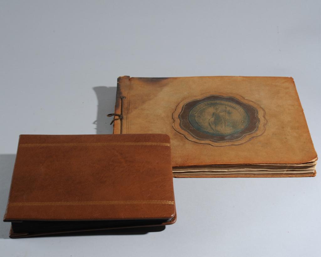 2 University of Virginia Scrapbooks: 1920s, 1950s: The larger album dating to circa 1926-1927, the suede cover with stamped seal of the University of Virginia. Inside are 1920s postcards of UVA and many personal items, clippings, notes, ephemera relat