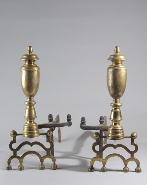 Early 19th C. Tall Brass Andirons: Urn shaped with acorn finials, openwork legs above four small bun feet, and with rough, blacksmith-forged iron bars. Approx. 23" in height, 23" long, 9 1/2" wide.