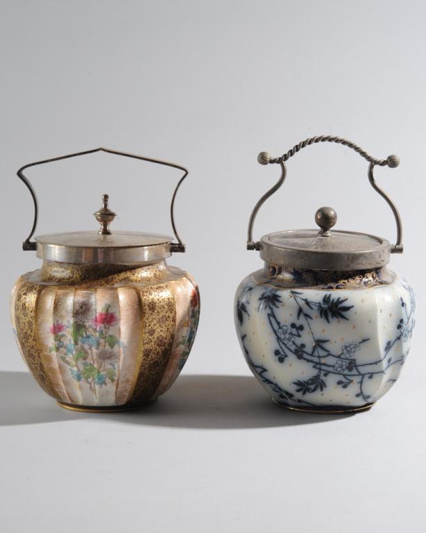 2 Doulton Burslem Victorian Biscuit Jars: One flow blue gold, the body with "tapestry" or shagreen type surface, the other jar with fluted sides painted with chrysanthemums between brocade panels. Both with silverplate lids and handles. Talle