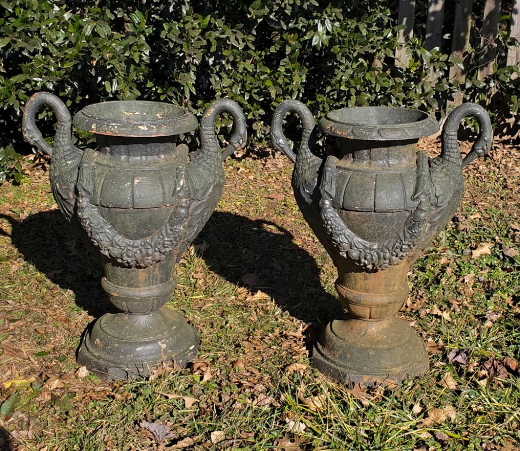 Pair Cast Iron Black Painted Swan Garden Urns: Pair of black painted cast iron garden urns with swan form handles, garland motif, no visible foundry mark, in as-found condition.H: approx. 28".