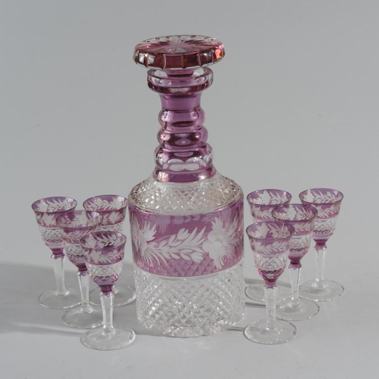 Bohemian Decanter & 8 Wine Glasses: Red cut-to-clear glass, floral motif.Decanter H: approx. 10 3/4".Wine glass H: approx. 4".