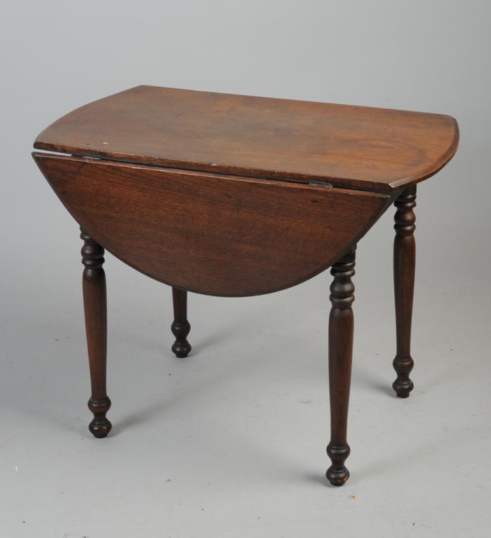 Diminutive Antique Drop Leaf Table: Molded edge top, two drop leaves, turned legs with painted date 1880 to underside. In as-found condition.H: approx. 20"W: approx. 14 1/2" closedD: approx. 25 1/2"Each leaf: approx. 22 1/2" x 7 1/2"