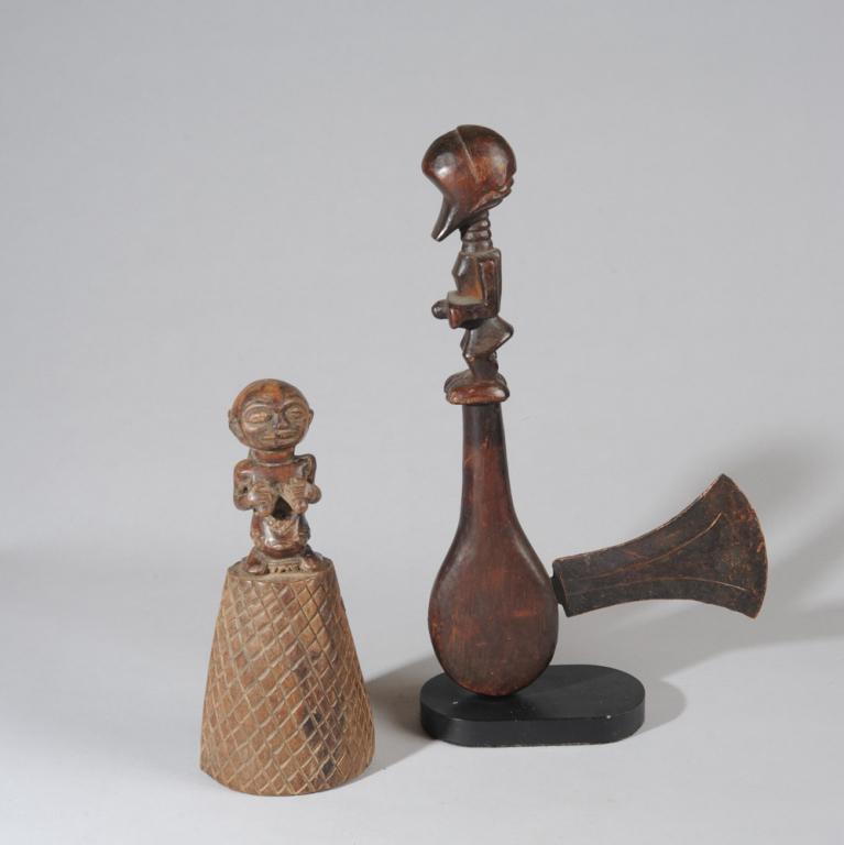 Songye Ceremonial Axe, Luba Bell: The carved wood axe handle with male figural finial of stylized form, with featureless, mask like face, ringed neck, hands cupping the protruding umbilicus, short legs with bent knees. The axe head of