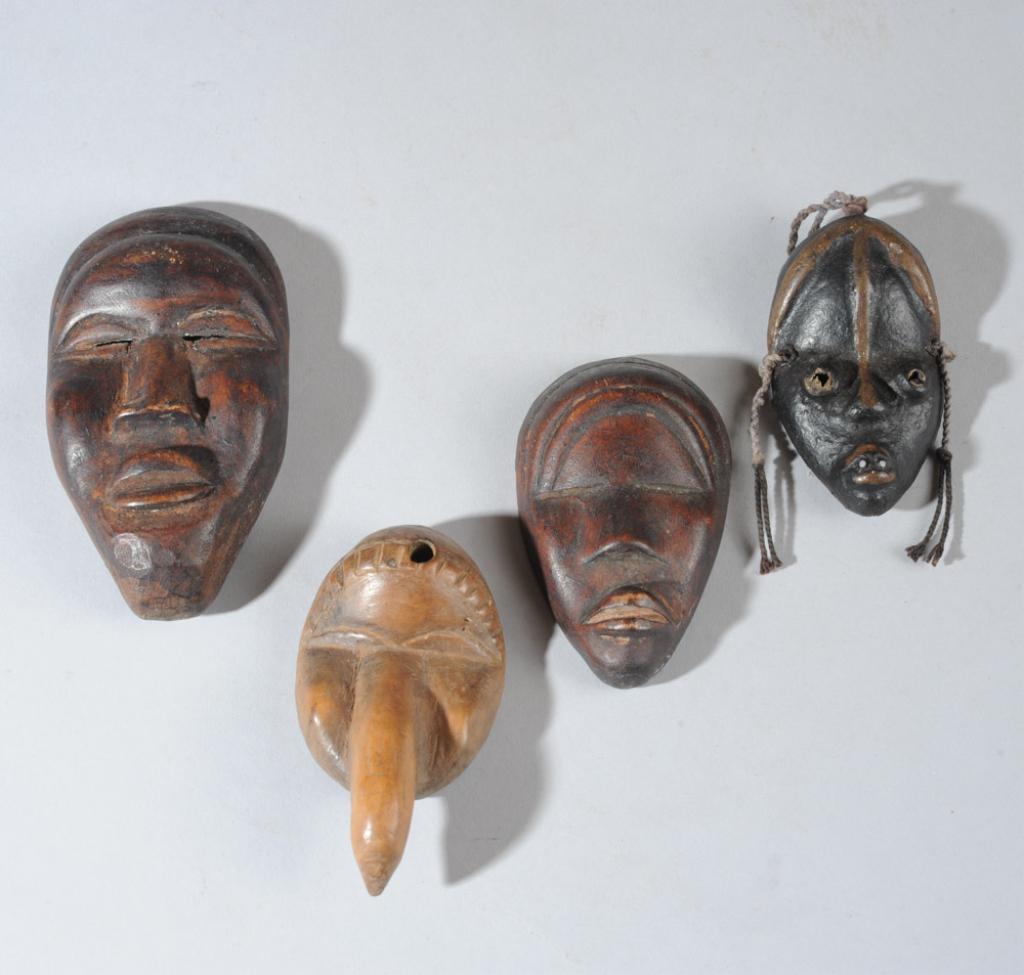 Four Miniature Dan Passport Masks: Three anthropomorphic masks and one bird mask. Three are wood, the smallest is clay. Largest approx. 4 1/2" x 2 3/8". Provenance: Estate of Thomas McNemar, (1931-2020.) McNemar lived and collected thr