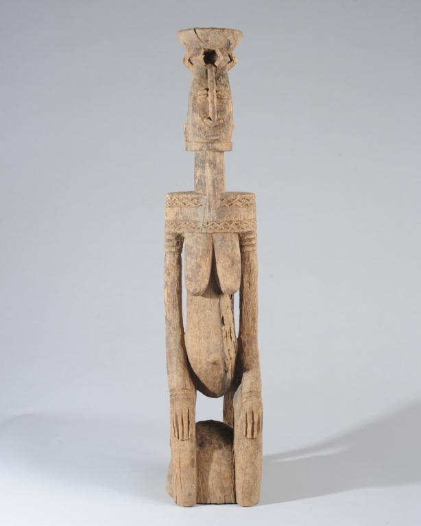 Fine Dogon Kneeling Female Figure: Exceptional balance and harmony present in this serene kneeling figure; the flare of the openwork bowl is echoed in the bell-shaped profile of the head, in the downward curve of the thighs, and the do