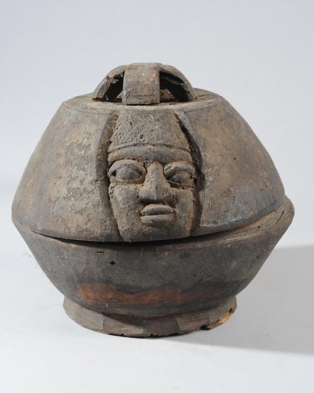 Yoruba Divination Bowl, Nigeria: The lid with face carved on one side, raised handle. Interior undivided. Somewhat encrusted surface. Approx. 10 1/2" H, 10 1/4" D. Provenance: Estate of Thomas McNemar, (1931-2020.) McNemar lived and 