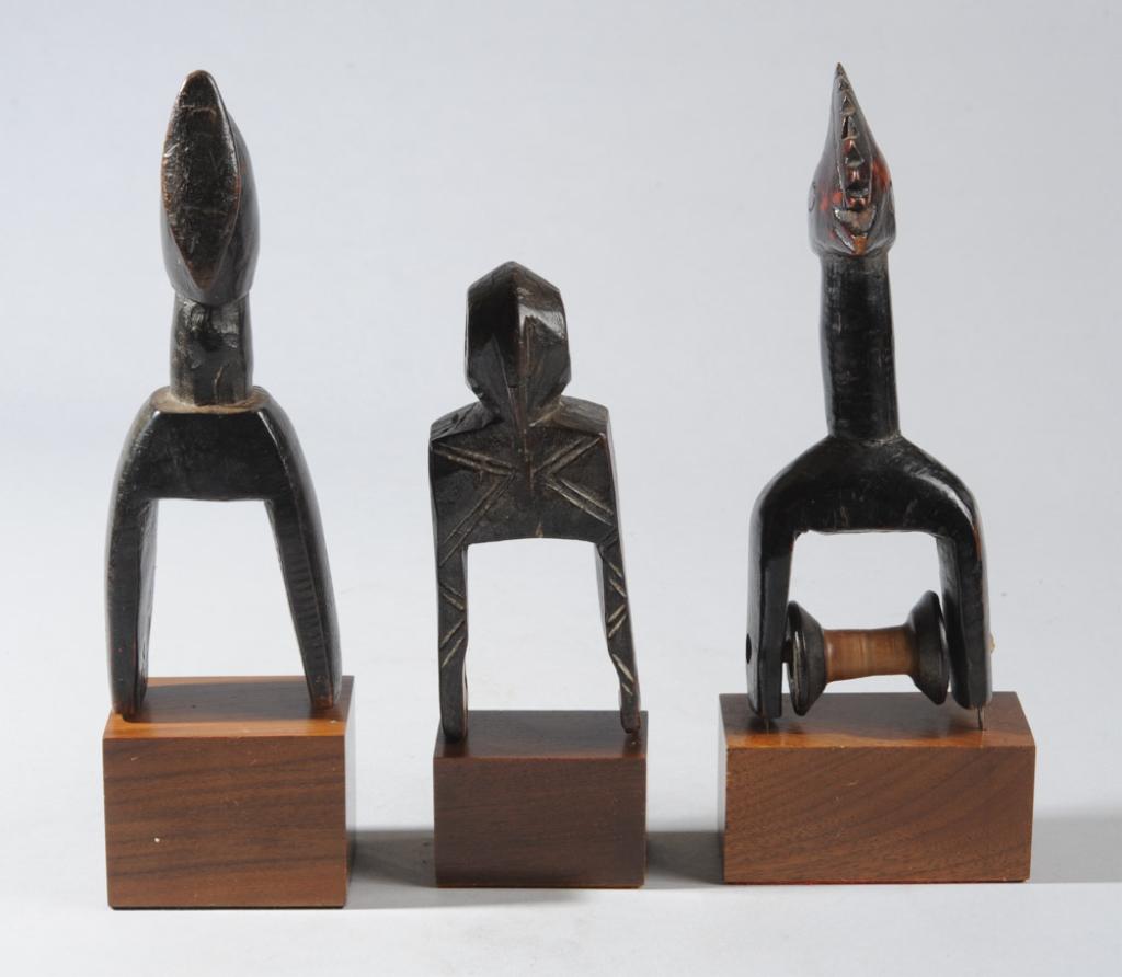 Three West African Heddle Pulleys: With bird form finials in varying degrees of abstraction. Likely Baule or Senufo, Ivory Coast. On custom gallery stands. Tallest, including stand, approx. 9 1/2" H. Provenance: Estate of Thomas McNema