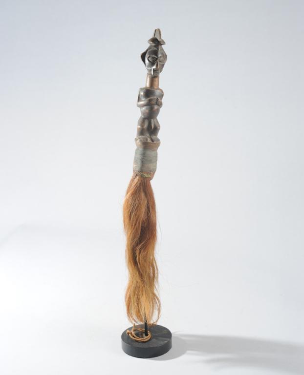 Yaka Fly Whisk, D. R. Congo: The handle with nkisi type figure with characteristic upturned nose. Both the figure's neck and the ferule are wrapped with copper wire. The whisk itself is of long reddish brown animal hair. On custo