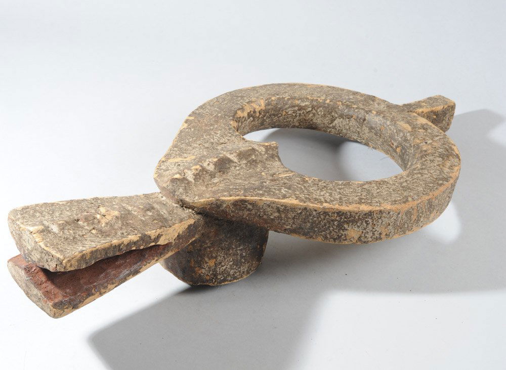 Buffalo Head Crest Mask, Mama, Nigeria: Elegantly abstract carved wood head crest representing a buffalo. The horns join into a circle above the triangular face with notched ridge and the long, notched snout. Mama artist, northern Nigeria.