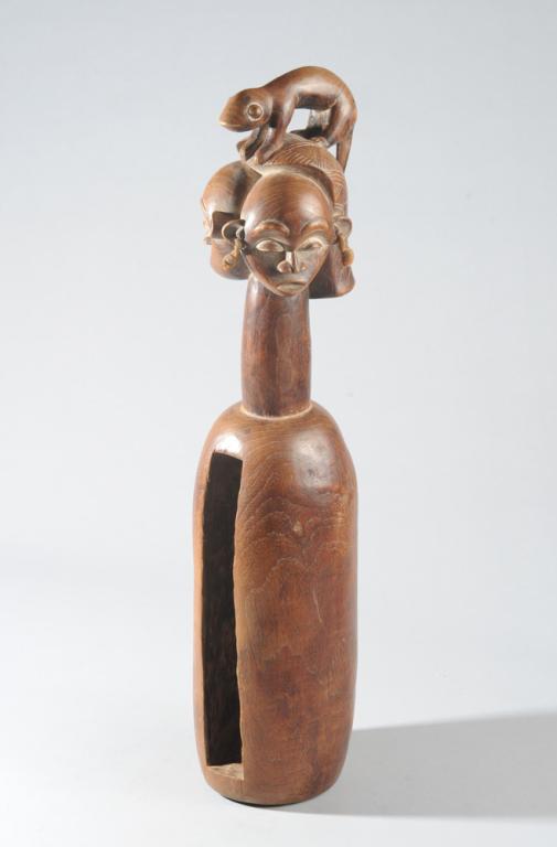 Yaka Slit Drum: With Janus head on long neck, topped by a lizard or other small animal. The hollow cylindrical drum as used for divination as well as rhythm. Approx. 24 1/2" H. Provenance: Estate of Thomas McNemar, (