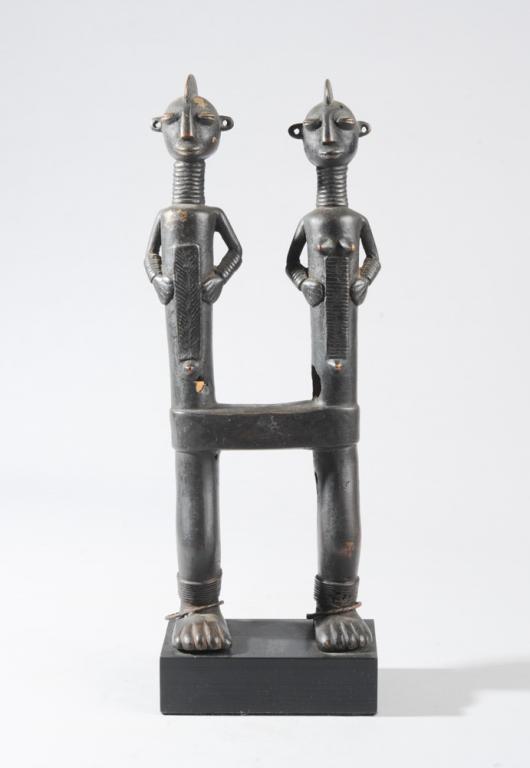 Chamba Bronze Figure, Nigeria: Male and female pair, joined at the waist and sharing two legs and feet between them, a bracelet on each ankle. Black patina. On custom gallery base. Approx. 16 1/3" H, (including base) Provenance: Es