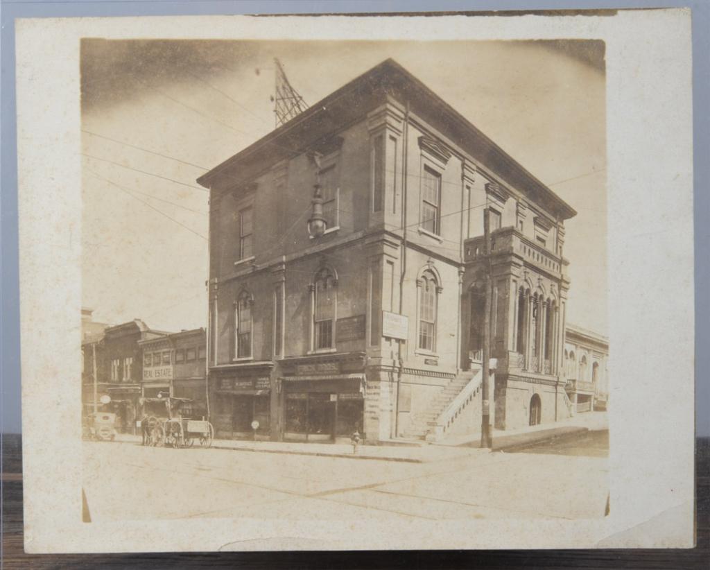 c1910 Charlottesville Va. Photo Old Post Office: Early 20th C. photograph of the old Charlottesville Post Office and including several storefronts, including W. L. Draper & Co Harness, Saddlery and Auto Suppies, H. W. Hilleary, Frick Bros. House Wir