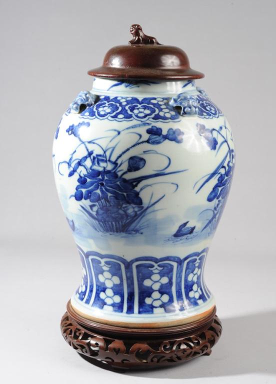 Chinese Blue & White Baluster Vase: Large Qing vase decorated with duck pairs among lotus in deep cobalt underglaze blue, with lappet border at base, ruyi border at shoulders. Four foo dog handles. With later carved wood base and lid wi