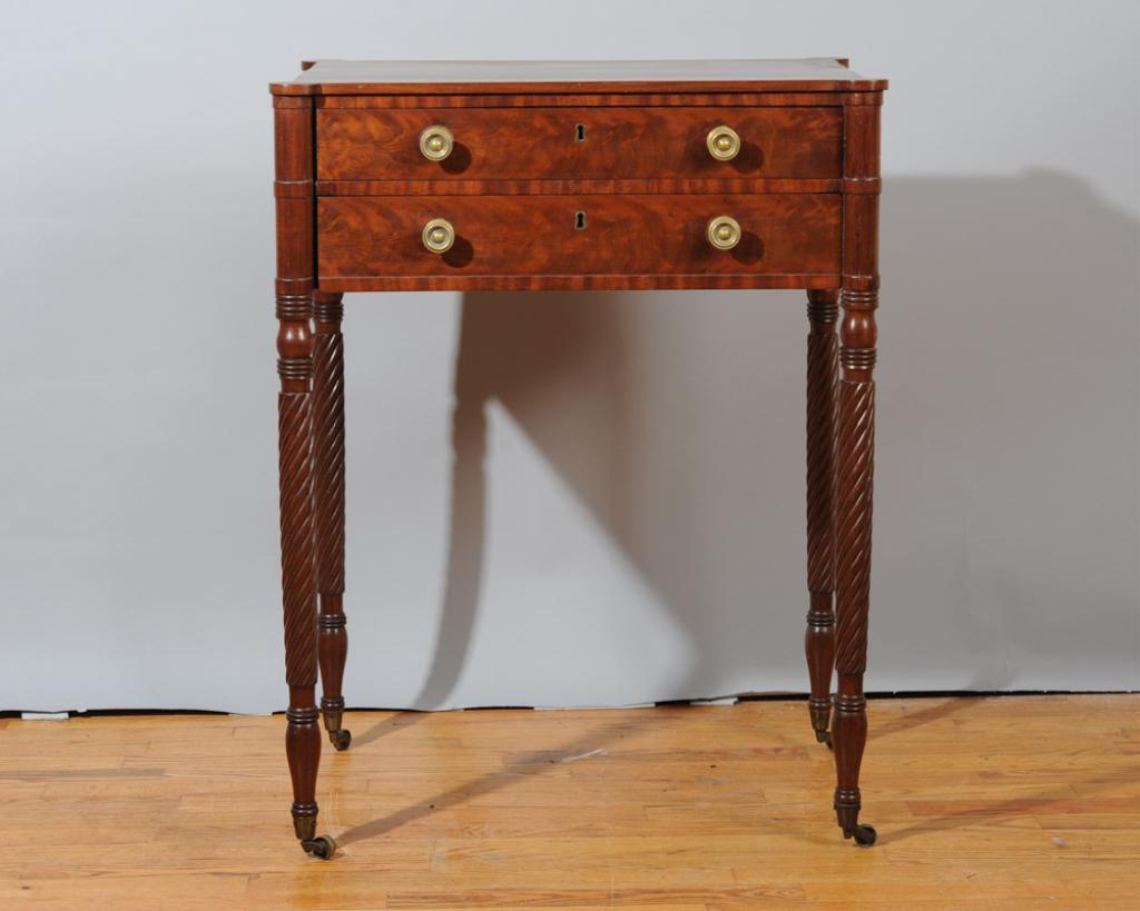 Early 19th C. New York Mahogany Sewing Stand: Circa 1805 - 1815, Mahogany primary with Poplar and White Pine secondary, two dovetailed drawers with brass pulls, reeded legs, some water damage.H: approx. 29 3/4".W: approx. 23".D: approx. 16 3/4".