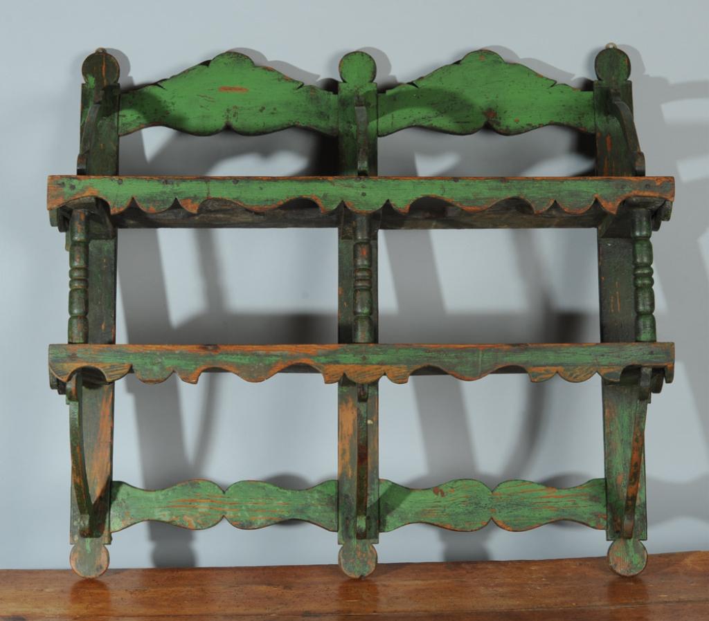 19th C. Primitive Wall Shelf, Original Paint: Antique hanging shelf with original apple green paint, the top shelf with circular cutouts, likely for potted plants, the lower shelf solid. Marvelous folk style with curved and turned supports, shape
