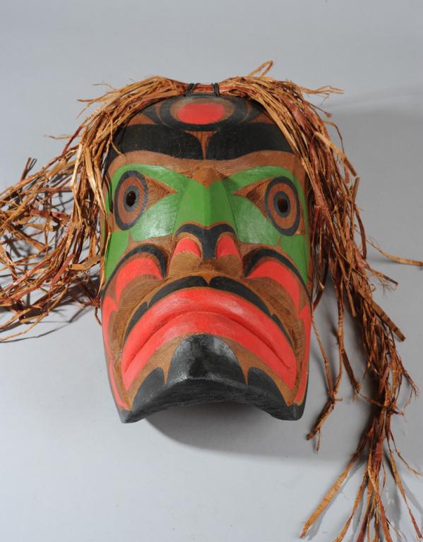 Northwest Coast Kwakiutl Mask, Victor Newman: First Nation Salish carved and painted wood mask with raffia, dated (19)96 and signed in ink to interior by Kwakiutl / Kwakwaka'wakw artist Victor Newman. Newman comes from a family of renown artists,
