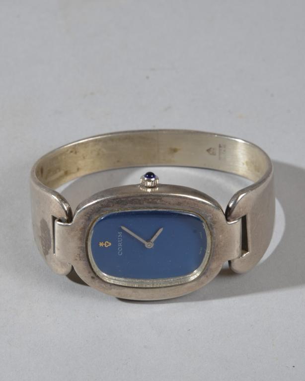 Corum Love Bond Sterling Lady's Bangle Watch 57300: Deep cerulean blue face with "Corum" with gold key logo and "Swiss Made", marked 57300 on case with logo and marked on band with 925. Minor surface wear, inside marks worn but legible. Inner circumfer