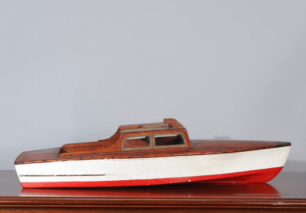 Vintage Wooden Model Boat: Circa 1930's finely hand crafted large model boat with planked bow and stern and with white painted hull with red bottom and blue waterline. Glass windshields, brass trim. Approx. 39" L, 12" W., 9 1/2